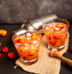 Acerola(Barbados Cherry) Caipirinha, Traditional alcoholic drink from Brazil in Dark background.