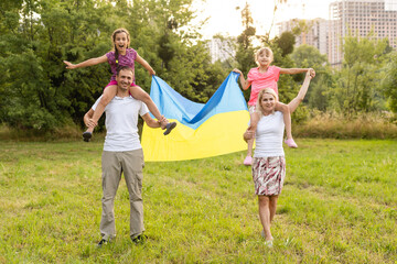 Naklejka na ściany i meble family with the flag of ukraine. Happy Independence Day of Ukraine. National Flag Day. Love for the homeland and symbols. Copy space.