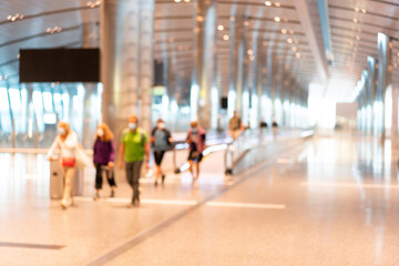 Abstract blurred passengers in an Asian airport background. Motion blur crowed of people walking...