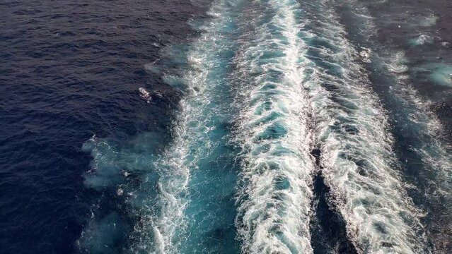 Still shot from rear of a cruiser. Mediterranean sea. Propulsion trail can be seen on the water from the engines turbines.
