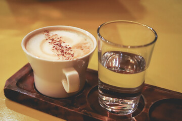 Cappuccino and a glass of water
