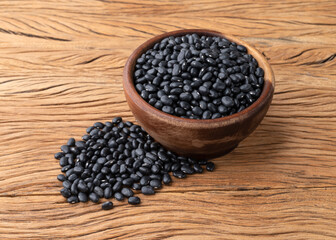 Black beans in a bowl over wooden table