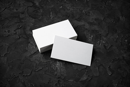 Blank business cards on black stone background. Mockup for ID. Template for graphic designers portfolios.