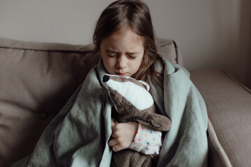 Stop war. Pray for Ukraine. we stand with Ukraine. Ukrainian frightened child under a blanket. The...