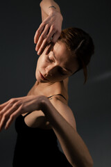 Naklejka premium Beautiful and slim girl warming up on a white background