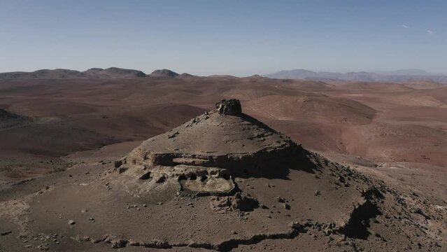 Aerial shot of a mountain in the south of morocco with many caves in it