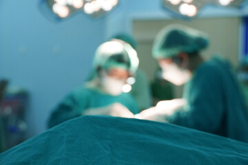 Doctors and assistant team during surgery in the operating room  blurry image