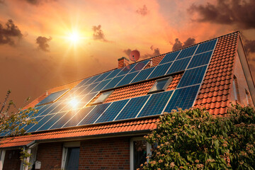 Photo collage of solar panels, photovoltaics on the red roof of a house and a beautiful sky with...
