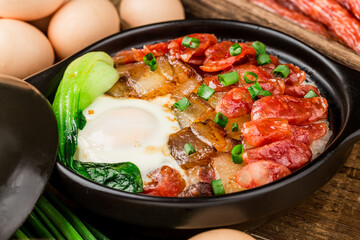 Cantonese style cooking of claypot rice with waxed meats