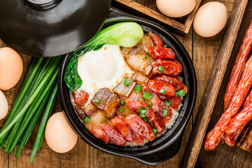 Cantonese style cooking of claypot rice with waxed meats - obrazy, fototapety, plakaty