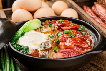 Cantonese style cooking of claypot rice with waxed meats