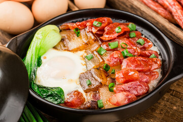 Cantonese style cooking of claypot rice with waxed meats