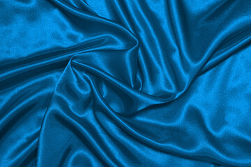 Texture of crumpled blue satin fabric, beautiful pattern, top view.
