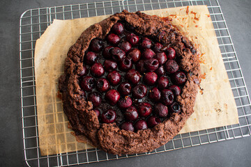 Bourbon Cherry Chocolate Galette Cooling on a Wire Rack: Overhead view of a freshly baked sweet rustic dessert