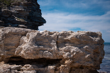 Stone mountains. Geological research near the sea. Natural background. Summer landscape.