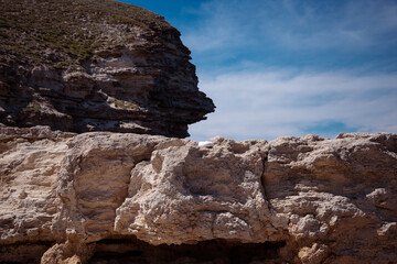 Stone mountains. Geological research near the sea. Natural background. Summer landscape.