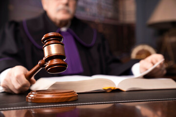Law and justice  – judge in toga with the gavel during trial