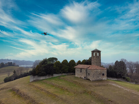 Drone flying over a rural church in the countryside, Garbagnate Milanese, Lombardy, Italy
