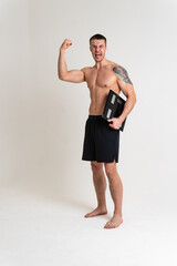 Fototapeta premium Man with weights health pondered, health and sports on a white background back hurt injury, cramp spine isolated young adult, illness expression. sickness, back suffer attractive