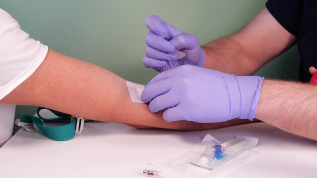 Blood donation concept. Injection for blood collection. Nurse or paramedic prepares the patient for blood donation. Blood test preparation. 