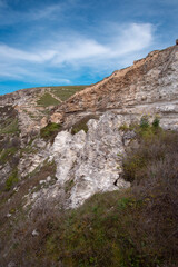 Stone mountains. Geological research near the sea. Natural background. Summer landscape.