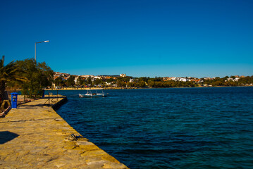 Obraz premium DATCA, TURKEY: View from the promenade on buildings and the sea in the city of Datca on a sunny day.