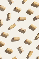 Creative pattern with wine corks on beige background with hard light and shadows at sunlight....