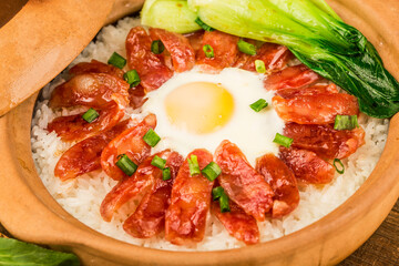 Cantonese style cooking of claypot rice with waxed meats