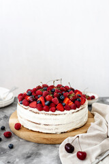 Rustic cake with fresh berries on a concrete background 