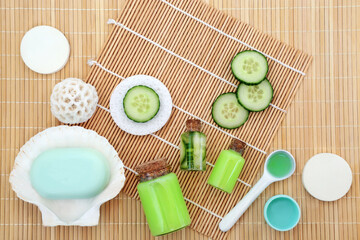 Cucumber skincare for natural plant based healing beauty treatment with slices, lotion, gel, soap, moisturizer and cosmetic sponges. On bamboo background. Alternative healthcare concept.