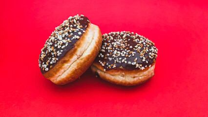 Chocolate donuts with nuts Tasty Delicious Food. Red background.
