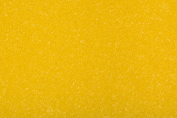 Yellow synthetic sponge detail texture, kitchen sponge textured background. Yellow banner