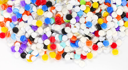 Color chads produced by punching holes in a sheets of colored paper. Office supplies tool concept