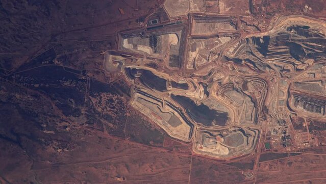 Mine industrial site Telfer in Australia aerial satellite view from sky. Sunrise animation based on image by Nasa