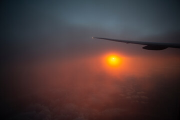 sunrise from the window with intercontinental airplane wing