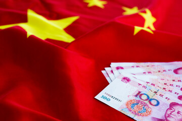 Cash money on chinese flag