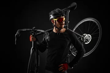 Plexiglas foto achterwand male cyclist with road bicycle on black background © producer