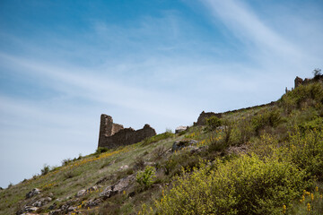 Fototapeta na wymiar Ruins of an old tower on the mountain.