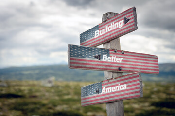 building better america text quote on wooden signpost outdoors with the american flag on it. Politics and voting concept.