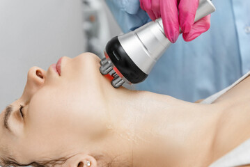Rf-lifting on face and neck. Rf lifting procedure in a beauty parlour.
