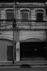 old abandoned building on street black and white