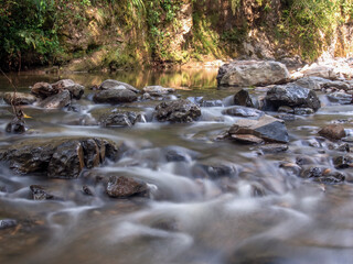 Naklejka na ściany i meble Multiple long exposure composite of the stream of the Moniquira river, a tropical tributary of the Suarez river, captured near the town of the same name in central Colombia.