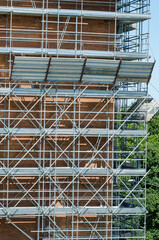 buildings: the scaffolding under construction, designed in every detail, for safety at work in accordance with the law, with parapet, pipes, joints and galvanized steel structures.
