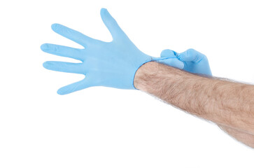 Individual protection products vinyl disposable gloves in the spread of virus and protection against infections. Men is dressing his hand in gloves. Corona virus, COVID-19.Isolated on white background