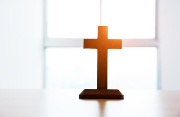 Small wooden cross on table