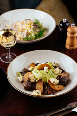 warm salad with meat and vegetables. restaurant menu