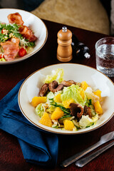 warm salad with meat and vegetables. restaurant menu
