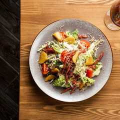 warm salad with meat and vegetables. restaurant menu