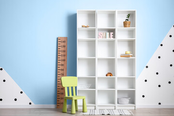 Modern shelf unit and chair in room