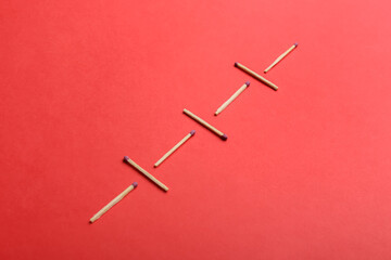 Whole matchsticks on red background. Social distancing concept
